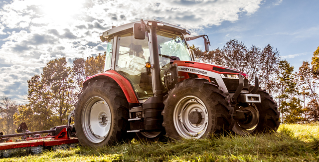 Massey Ferguson 5S mid-range tractor in the field during harvest operations under a bright sky
